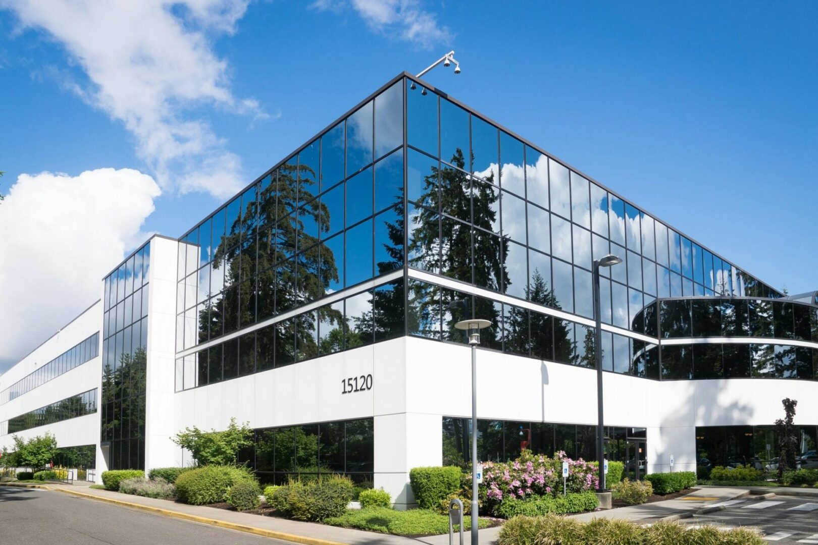 A building with many windows and trees in the background.